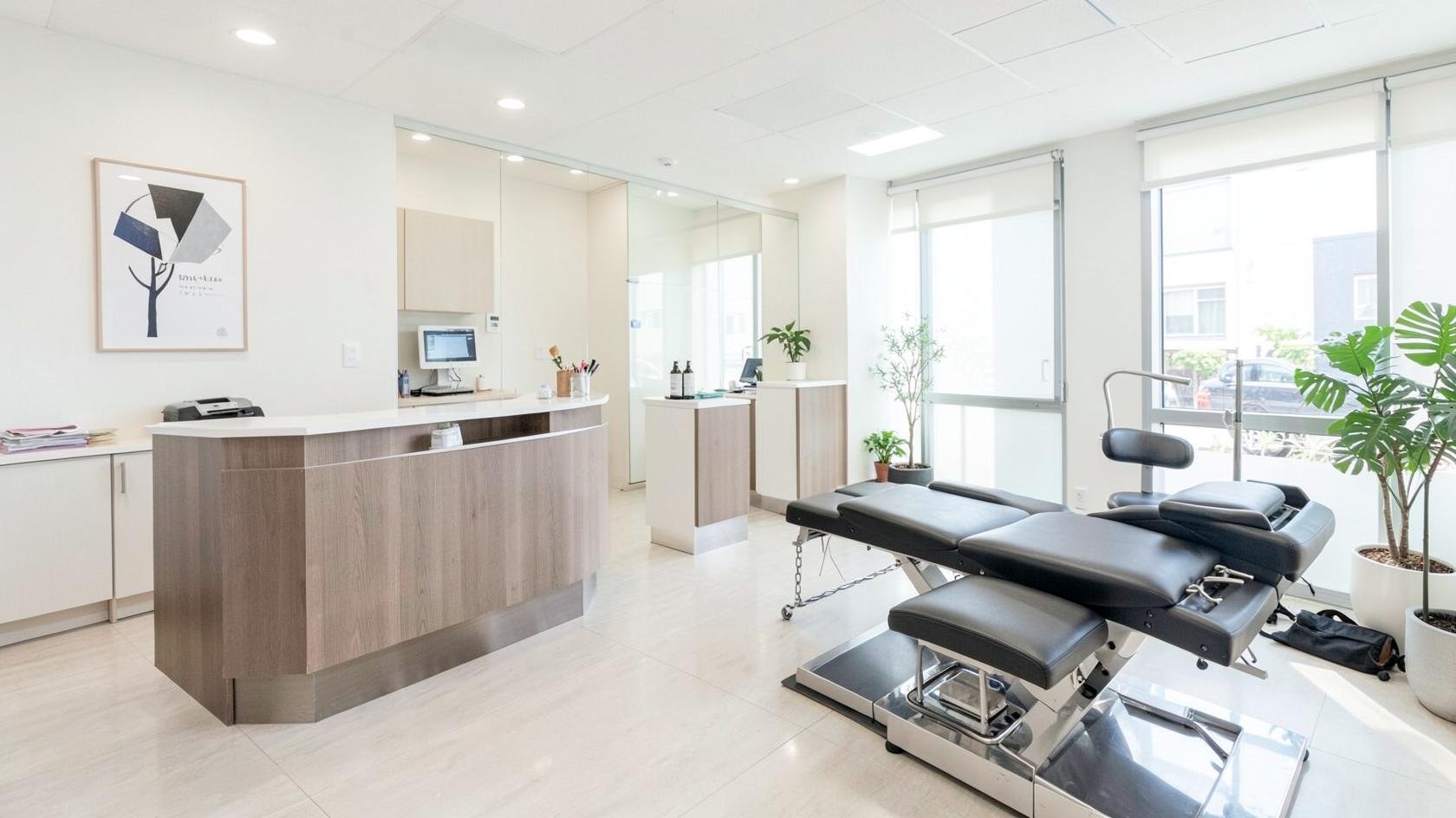 Bright modern chiropractic clinic reception and treatment area