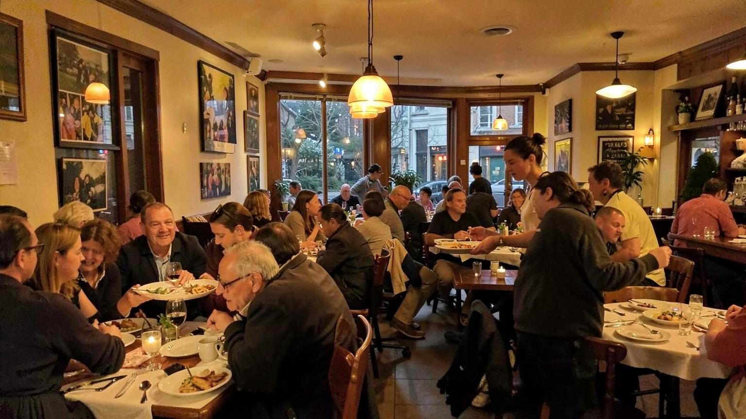Busy neighborhood restaurant dining room in the evening